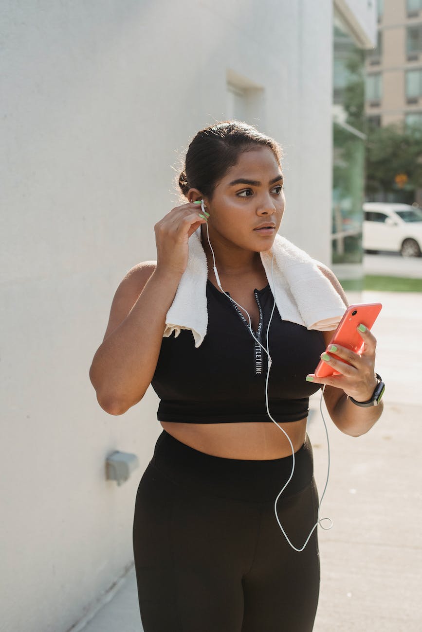 Woman exercising with her phone and earphones